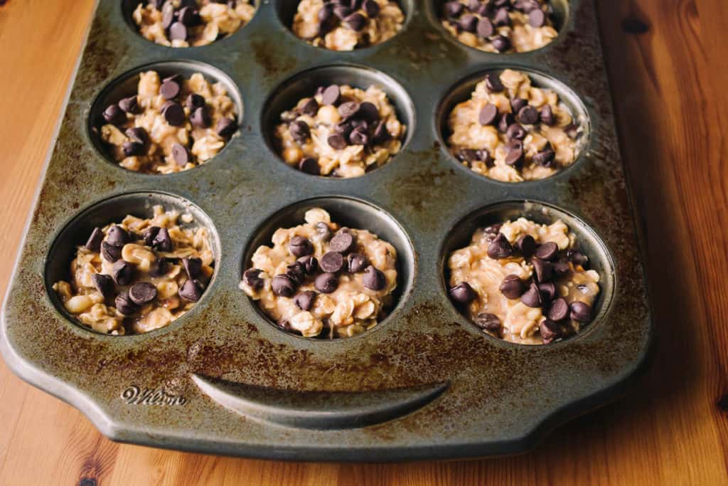 burnt muffin tin filled with banana muffins and chocolate chips