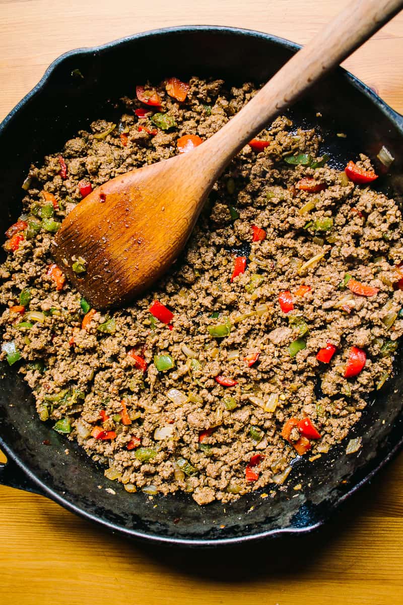 ground beef with peppers, onions in a skillet