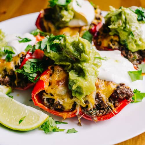 delicious plate of taco stuffed bell peppers with lime