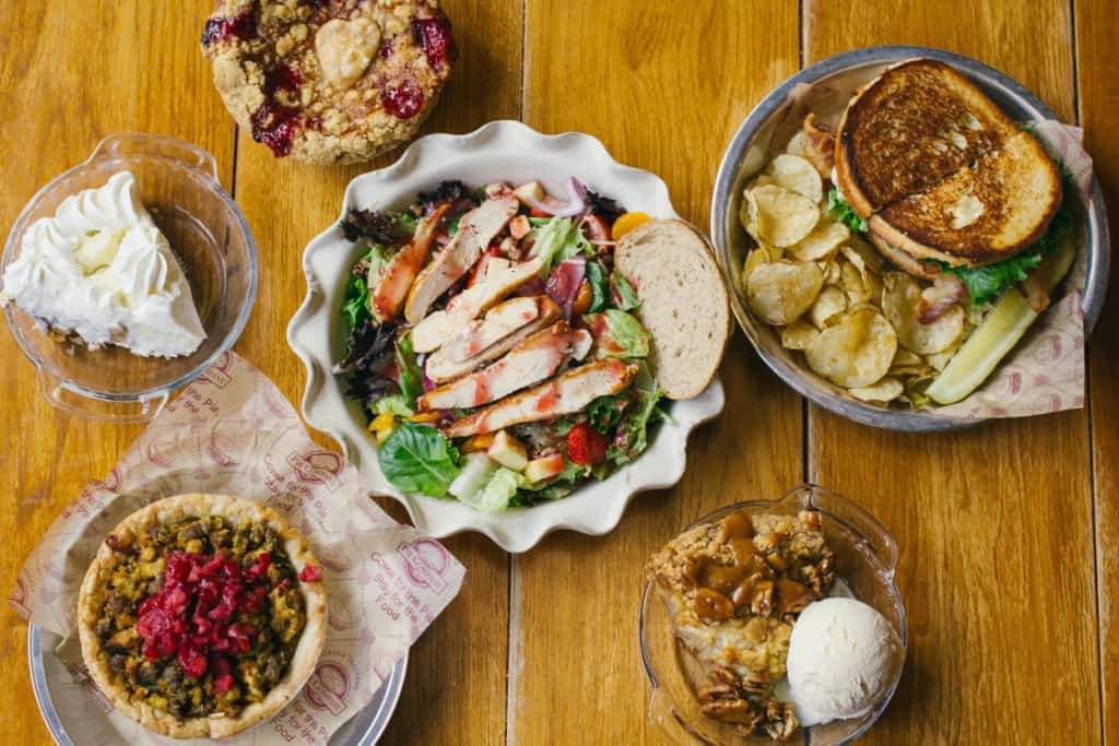 flat lay of food from grand traverse pie company including pie chicken salad and sandwiches