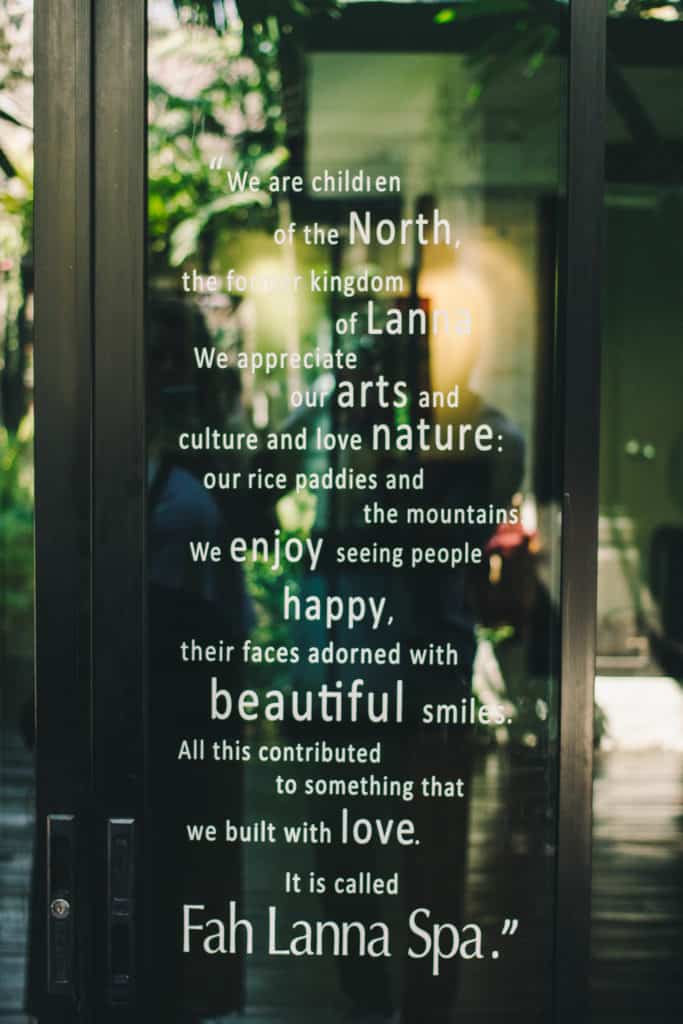 glass door with reflection with a lovely quote about fah lanna spa