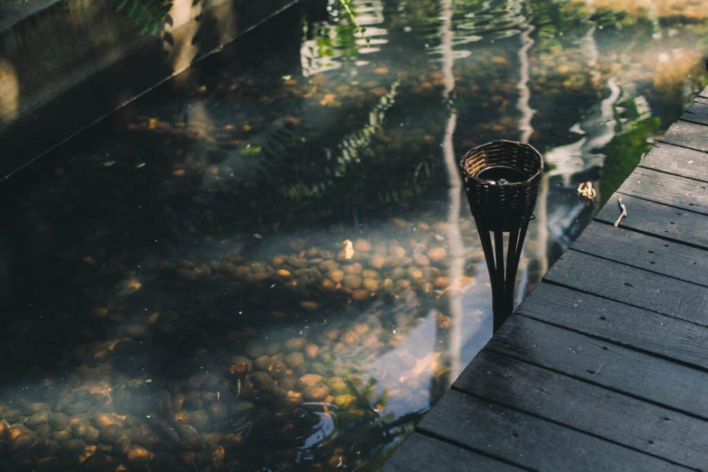 wooden boardwalk at Fah lanna spa with a torch  in the water