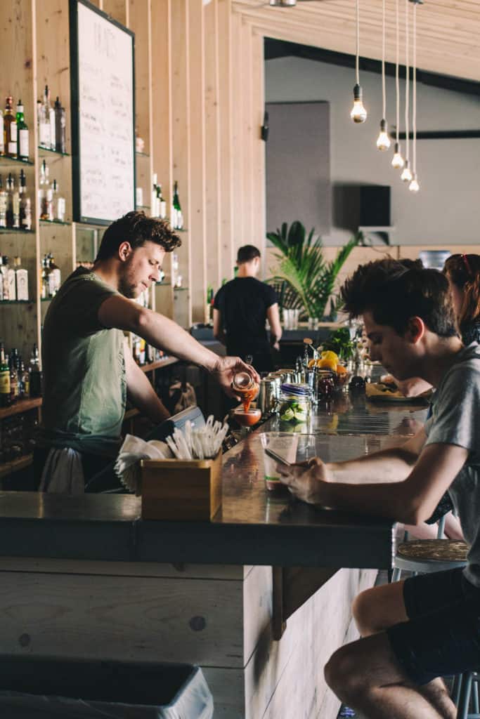 bar tender mixing drinks at the little fleet bar