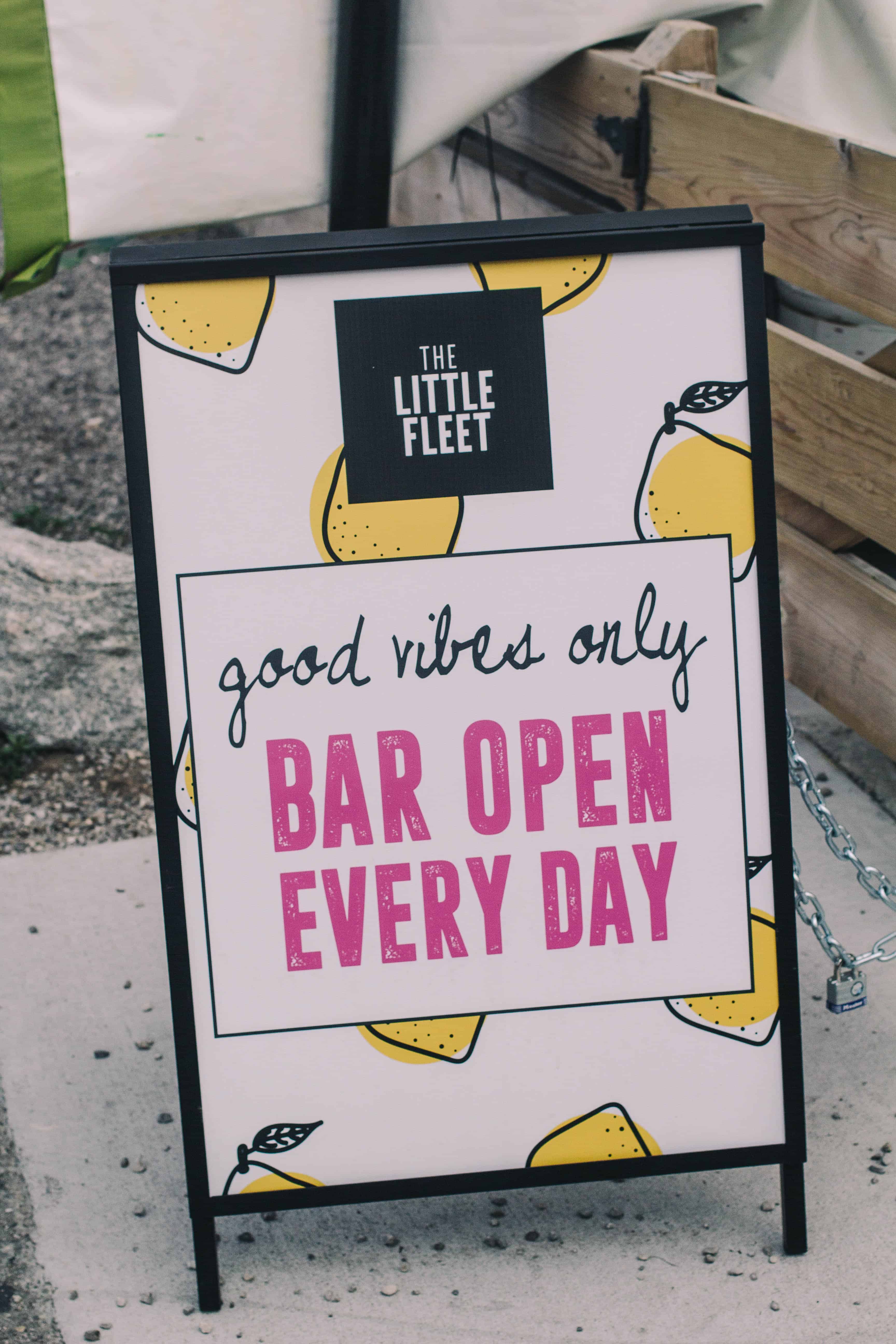 little fleet sign that states good vibes only bar open every day