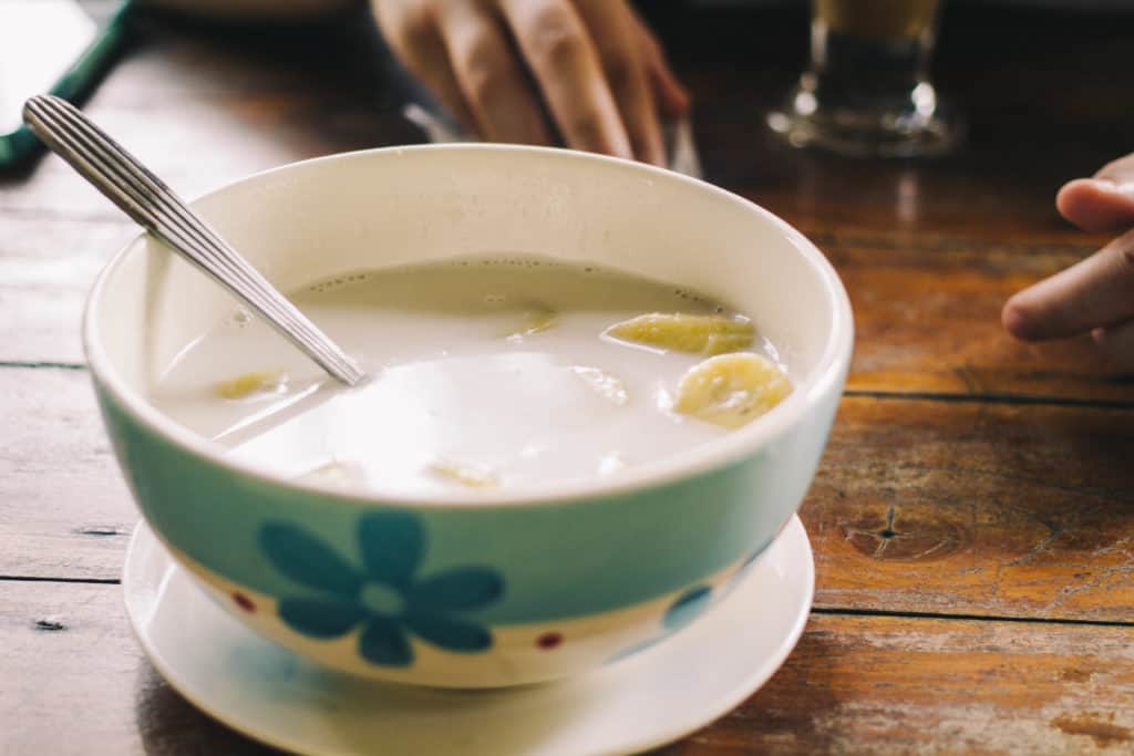 bananas in coconut milk in a bowl the best thai dessert