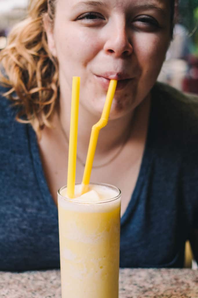 girl drinking fresh pineapple smoothie in thailand 