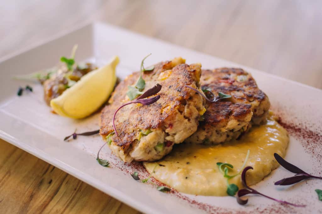 whitefish cakes on a rectangular white plate