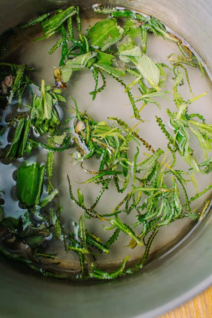 boiling fresh lavender and sage in a pot of water with sweetener