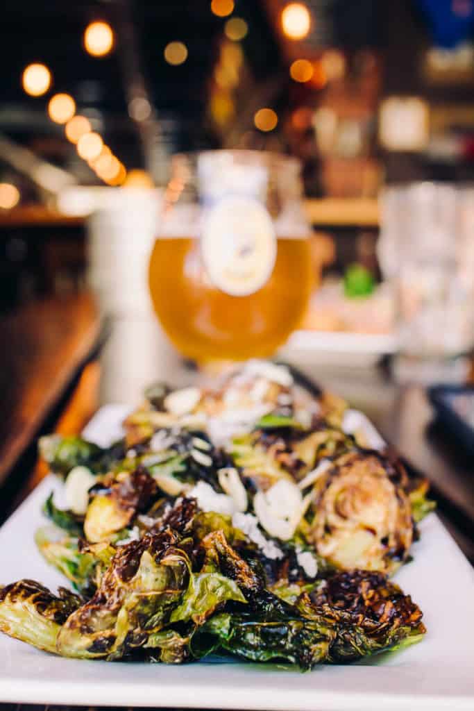 Brussel Sprouts from 7 Monks Taproom Traverse City with a beer in the back