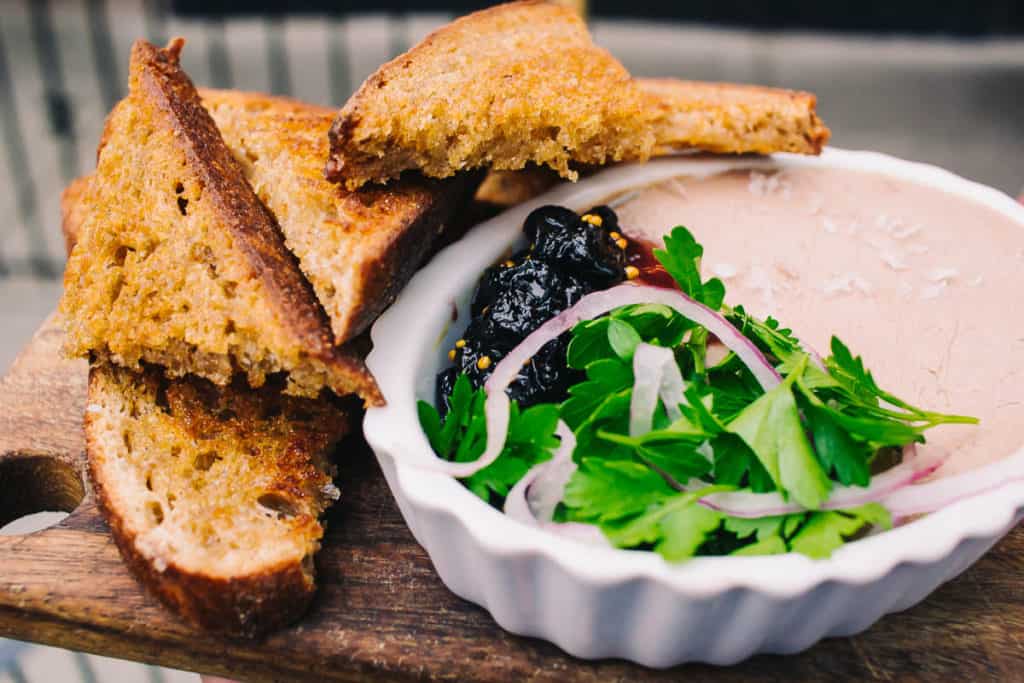 duck liver pate with toast pickled onions cherry preserves and greens at vincent