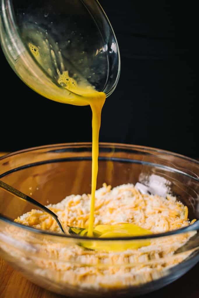 adding egg to the cheddar biscuit batter