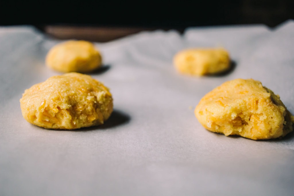 cheddar biscuit dough on parchment paper
