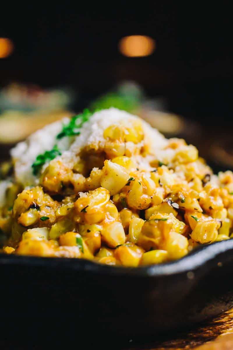 elote streete corn served in a small cast iron skillet