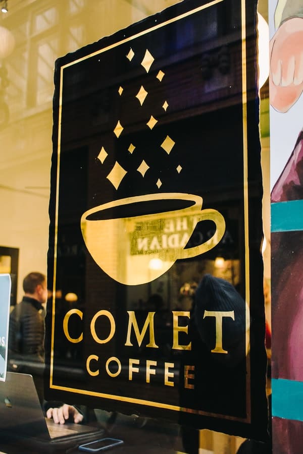 comet coffee sign on a glass window