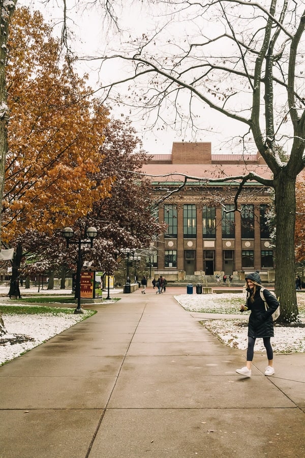 student walking on the cold campus of the university of michigan