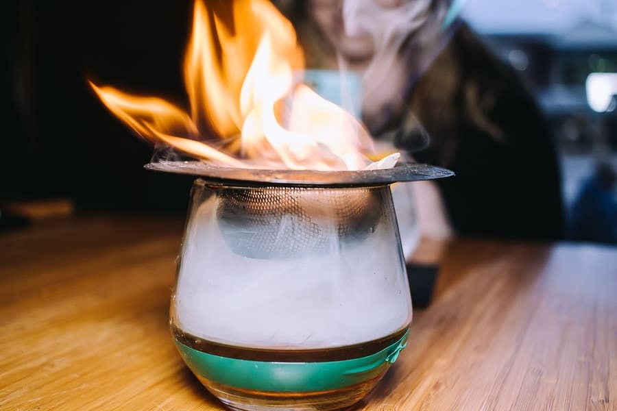 flaming drink with smoke inside and fire on top