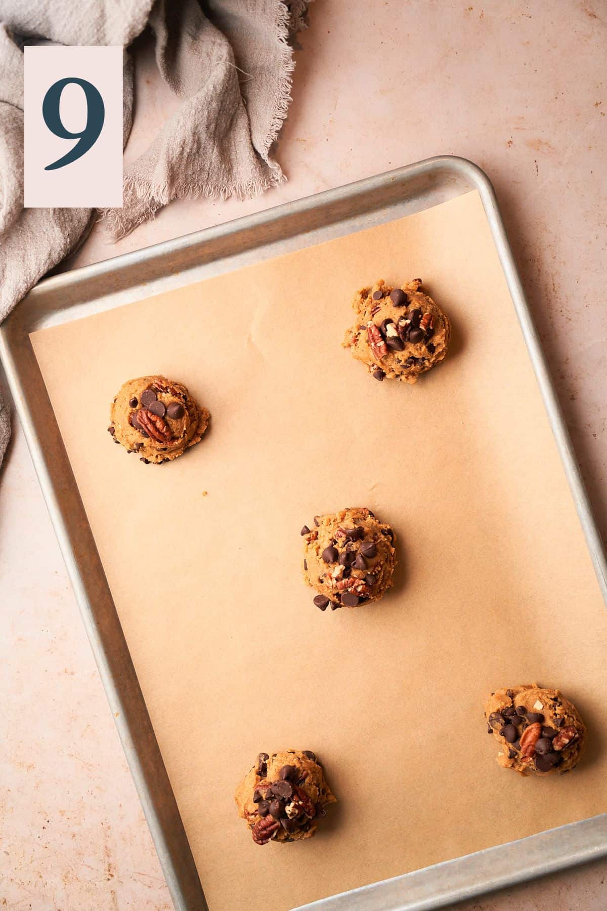 cookie dough balls on a baking sheet. 