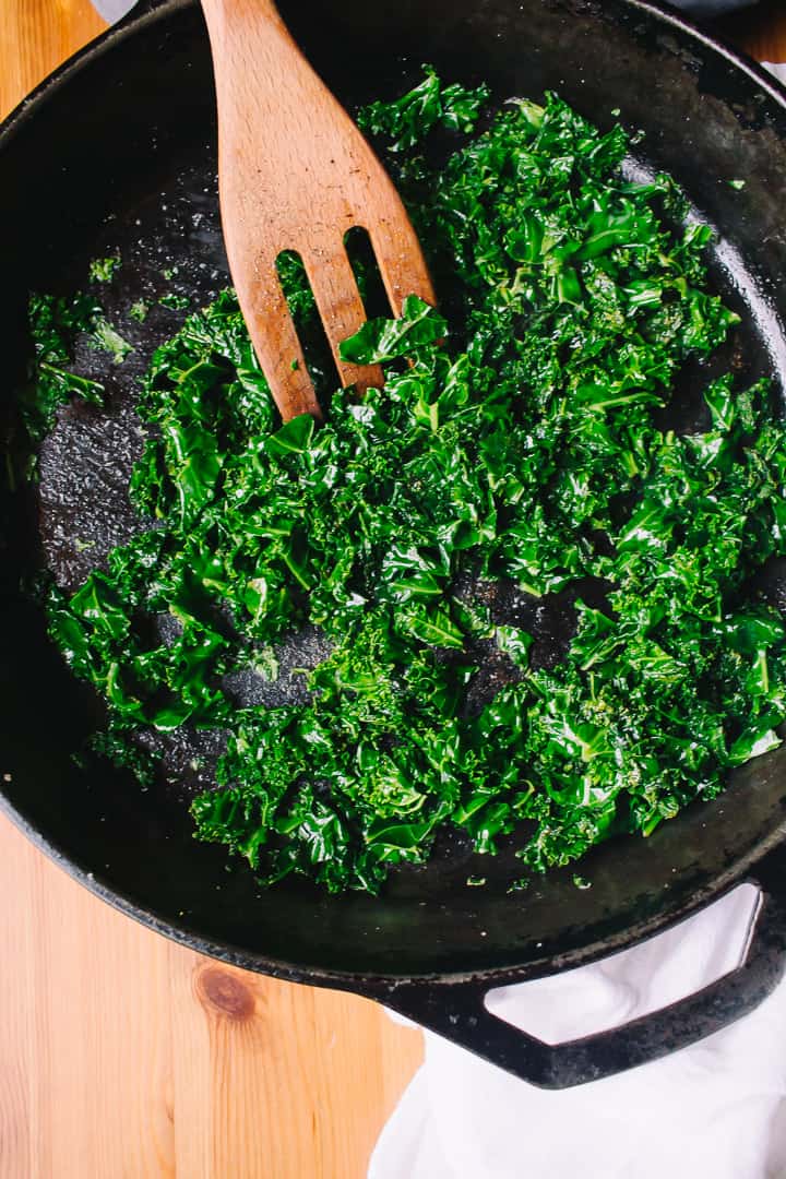 cooking down kale in cast iron skillet