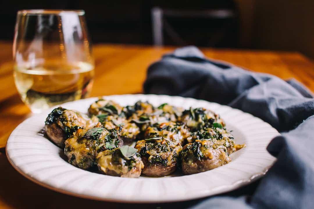 stuffed mushrooms and white wine with blue towel