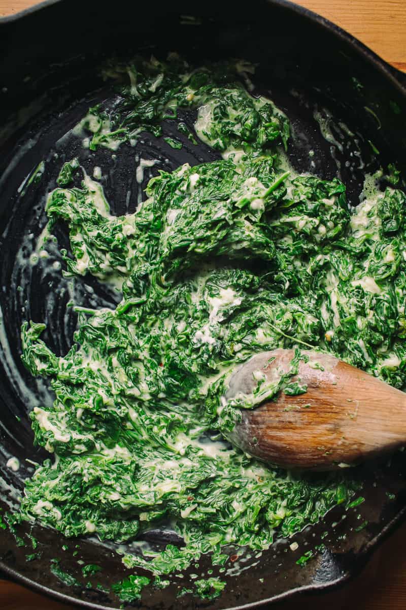 stirring cream spinach into skillet