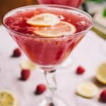 Two Low Carb Raspberry and Pomegranate Cocktails on a white linen napkin