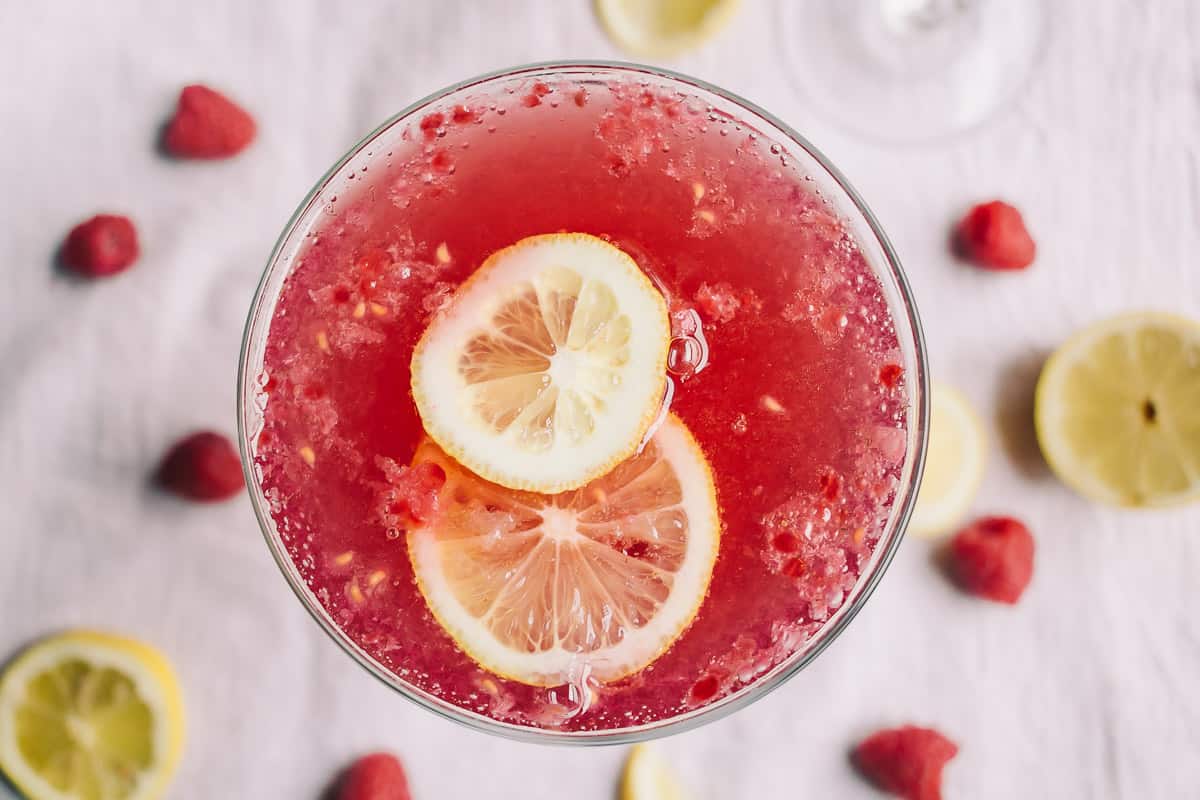 overhead view of a lovely low carb raspberry and pomegranate cocktail with lemons