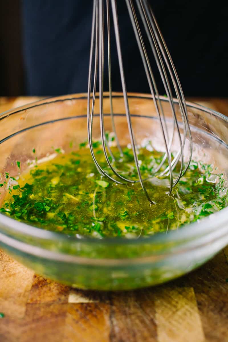 whisking a parsley based recipe with a whisk