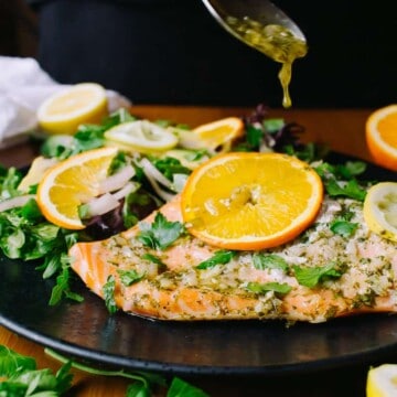 drizzling sauce on citrus glazed salmon