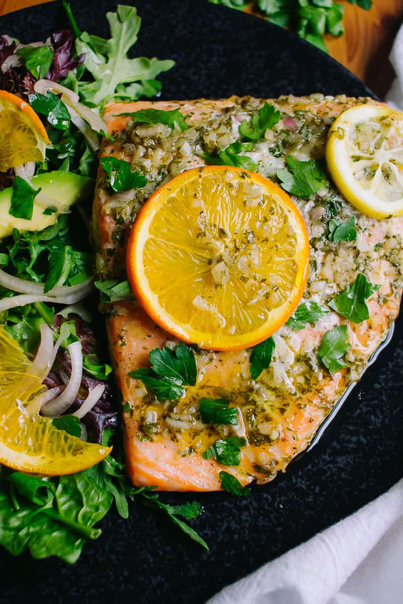 Salmon with orange slices and parsley