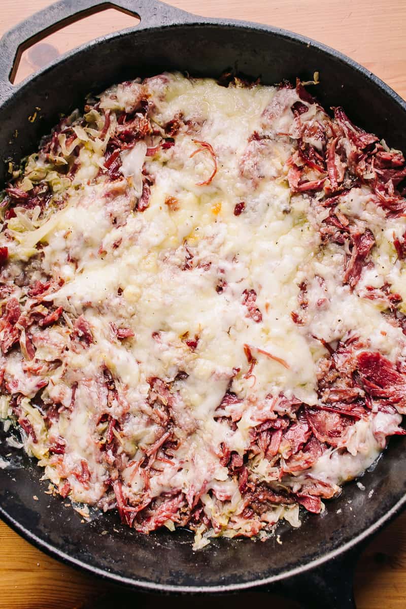 overhead of reuben skillet in a lodge cast iron skillet with swiss cheese