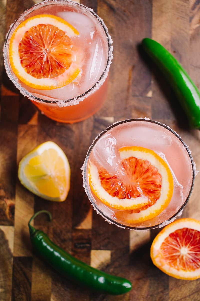 blood orange lemon and serrano pepper cocktails on a cutting board