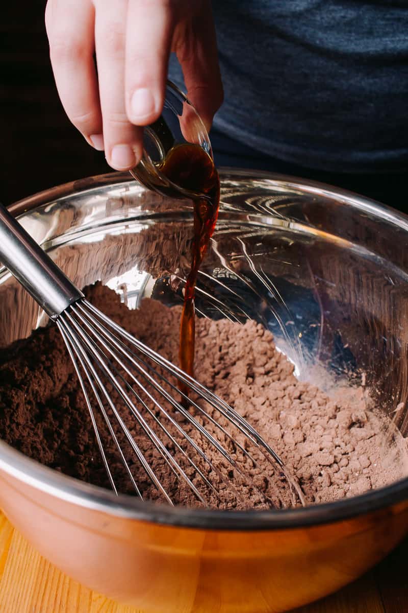 Pouring vanilla in chocolate batter