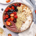 keto acai smoothie bowl with fruit toppings, hemp hearts and coconut flakes