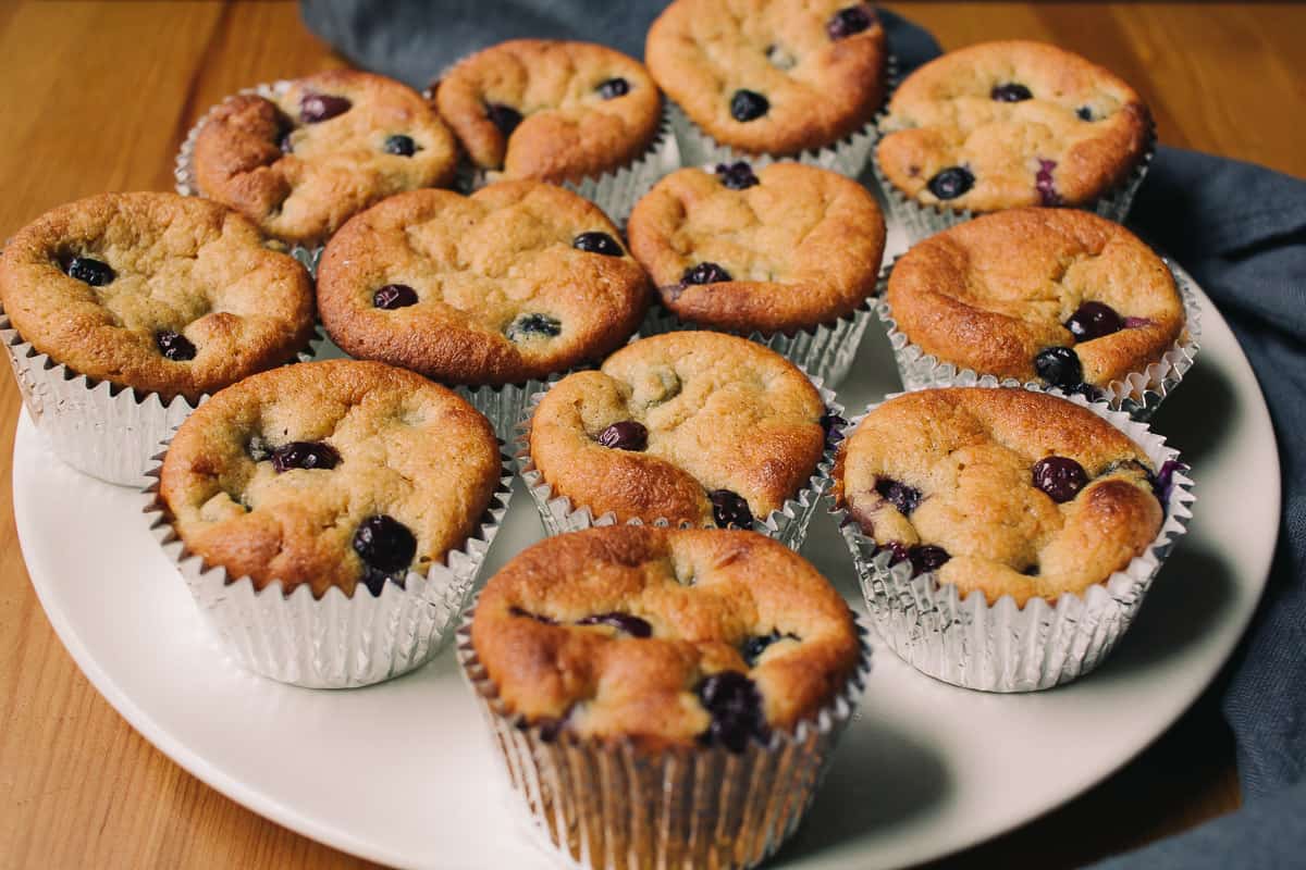 plate of low carb blueberry muffins with a grey blue towel