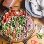 Strawberry Fields Salad with basil and strawberries white napkin and metal utensils