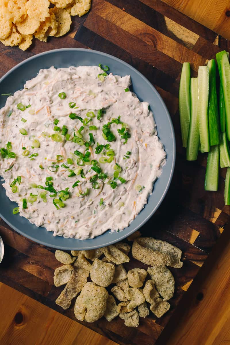 Bacon cheddar and green onion dip with pork rinds, whisps and cucumbers