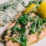 baked salmon with lemon wedges basil ribbons and creamed spinach