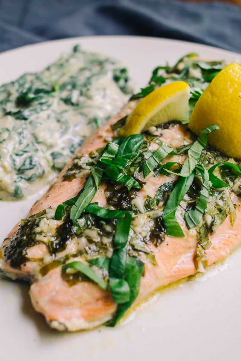 baked salmon with lemon wedges basil ribbons and creamed spinach