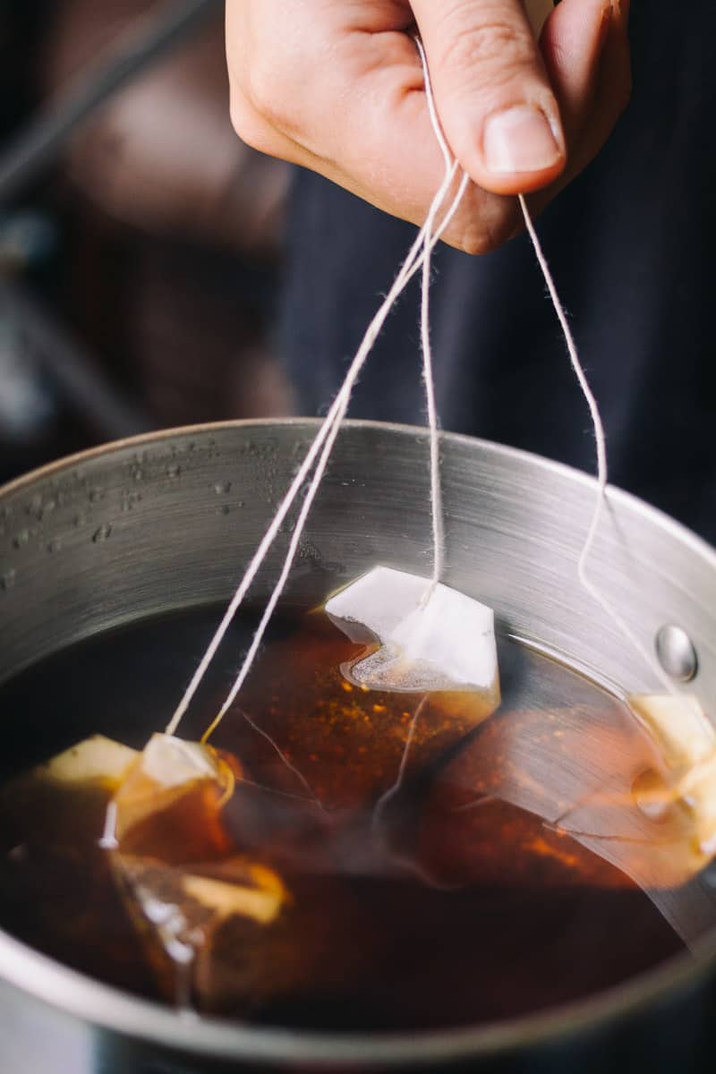 steeping tea bags in pot with fully steeped tea