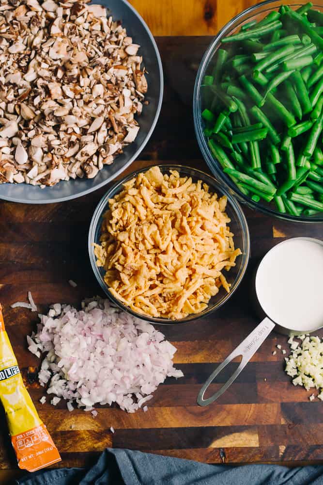 ingredients for green bean casserole on a brown chopping block