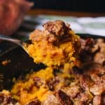 Spoonful of sweet potato casserole with pecan crumble topping