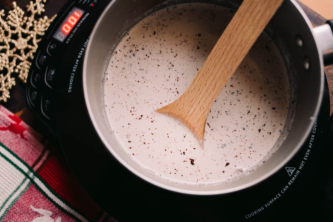 combining baker's chocolate and warmed milk in a sauce pan