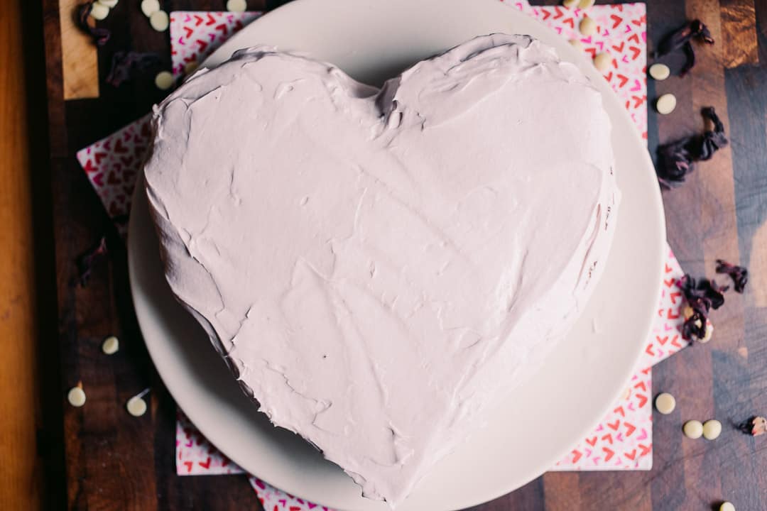 frosting a heart shaped low carb valentine's day chocolate cake