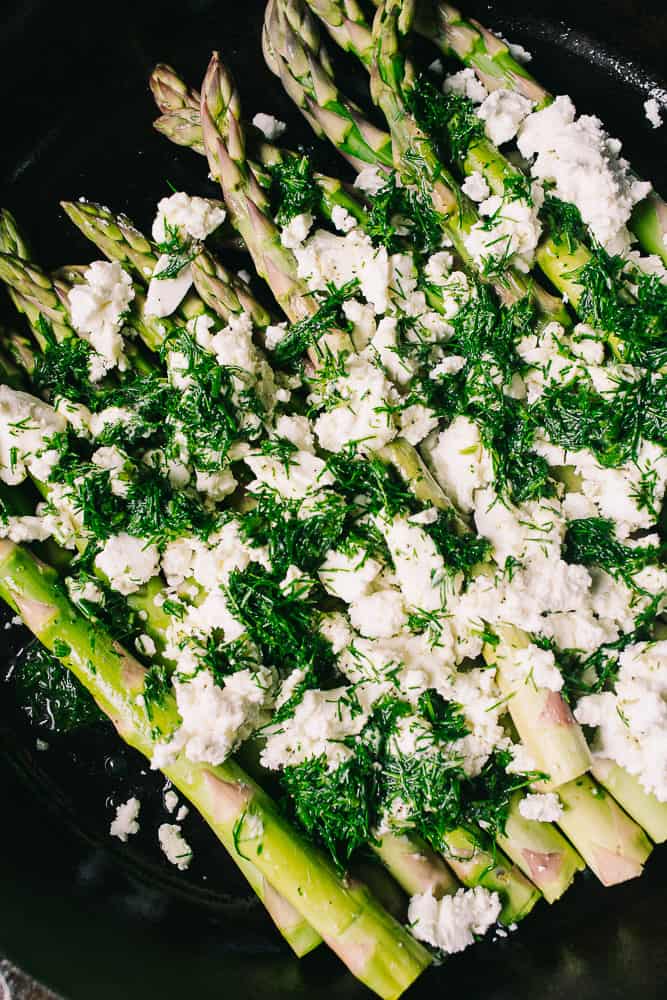 fresh asparagus, dill, goat cheese in a cast iron skillet