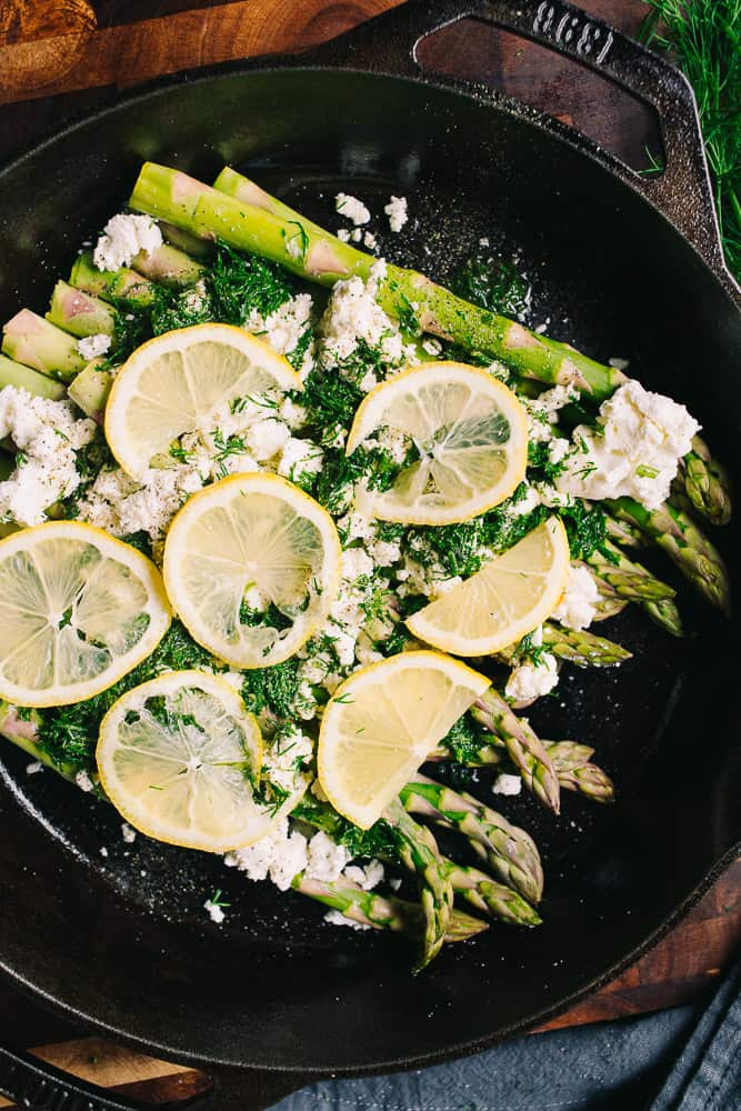 lemon slices overtop of fresh asparagus, goat cheese,