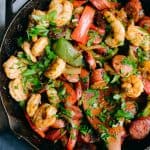 shrimp sausage and bell peppers in a cast iron skillet