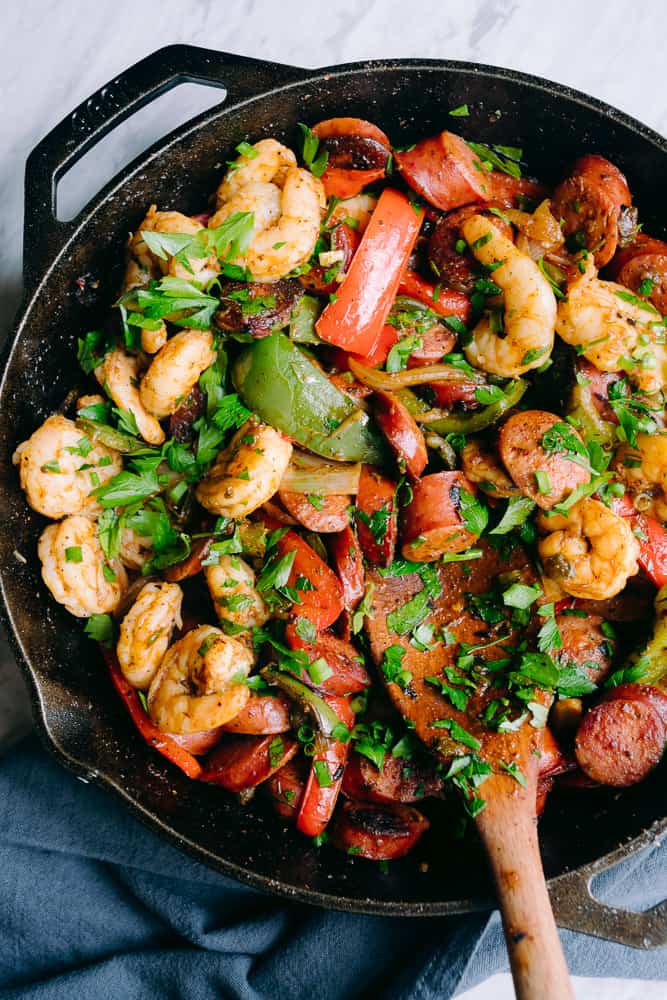 shrimp sausage and bell peppers in a cast iron skillet