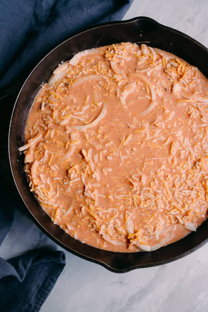 cheeseburger casserole skillet with wet egg mixture over top