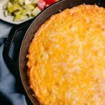 cheeseburger casserole in a skillet with burger toppings