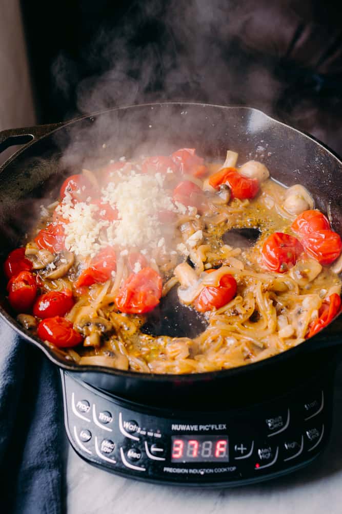 fresh garlic in a skillet with tomatoes and onions and mushrooms